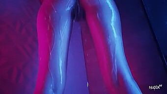 Slowed-down footage of water trickling over a model's breasts and genitals at 240 frames per second